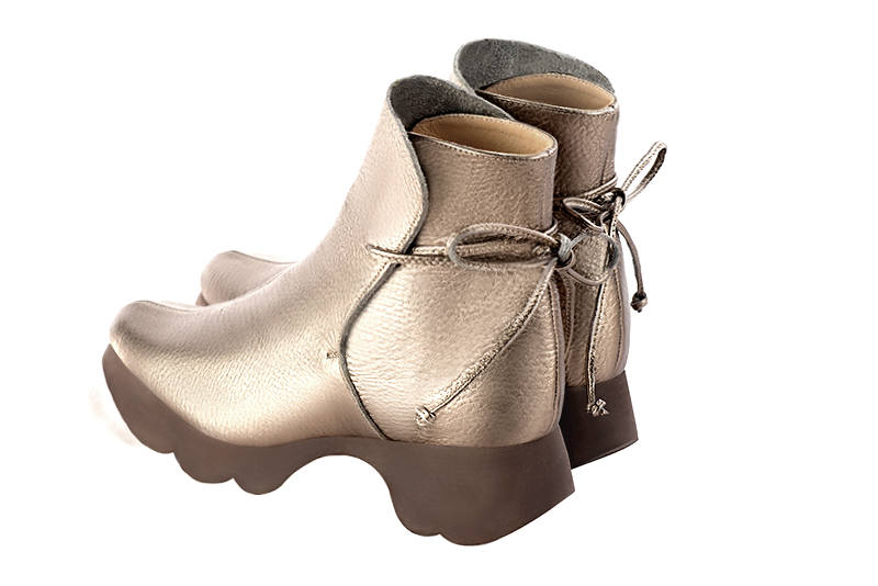 Gold women's ankle boots with laces at the back. Round toe. Low rubber soles. Rear view - Florence KOOIJMAN